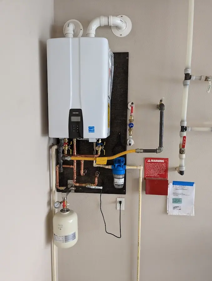 Professional plumber installing copper piping in a Gig Harbor home